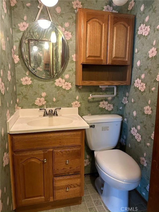 bathroom featuring toilet, vanity, and tile patterned floors