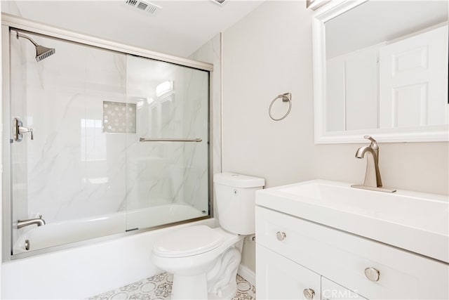 full bathroom with toilet, enclosed tub / shower combo, and vanity