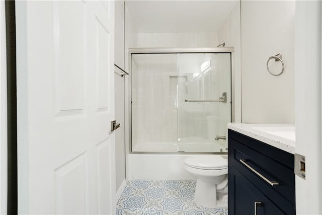 full bathroom with vanity, toilet, and shower / bath combination with glass door