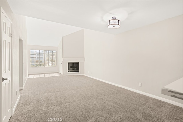 unfurnished living room featuring lofted ceiling and light colored carpet