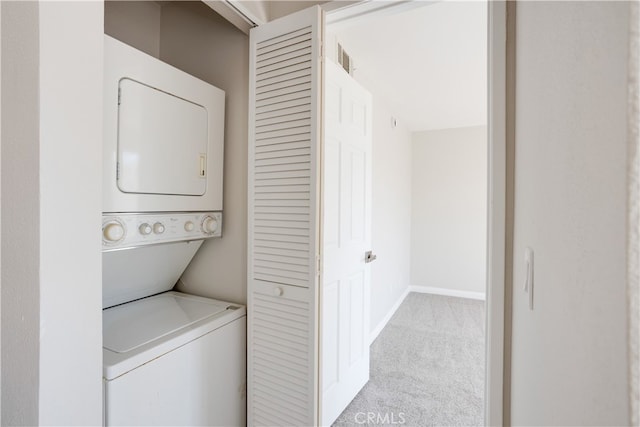 washroom with light carpet and stacked washing maching and dryer