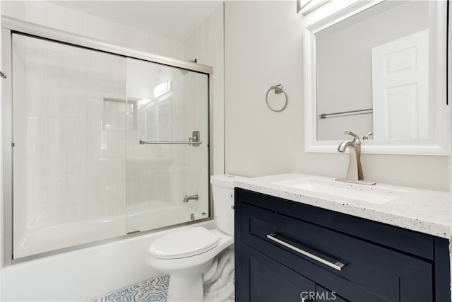 full bathroom with toilet, bath / shower combo with glass door, and vanity