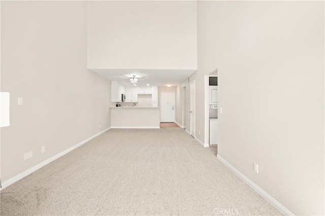 unfurnished living room with light colored carpet