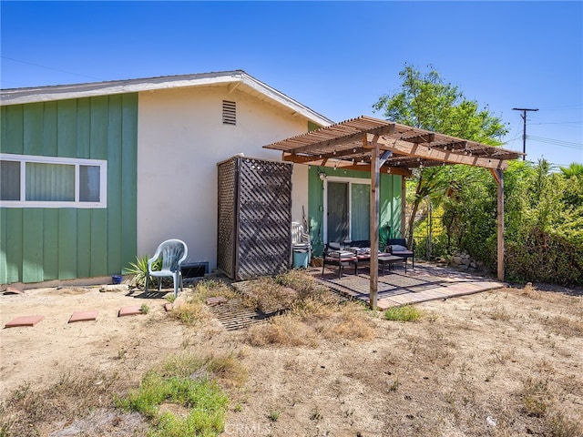 rear view of property featuring a patio and a pergola