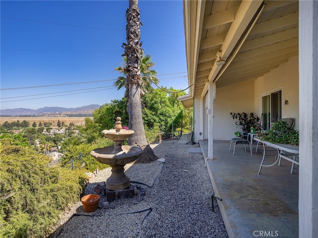 view of yard with a mountain view and a patio area