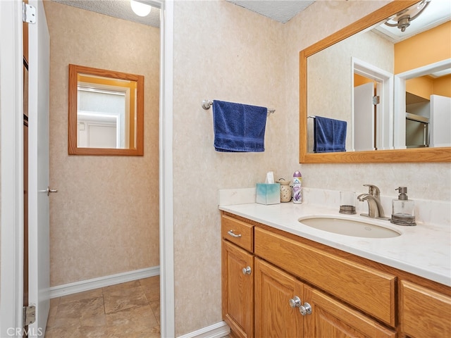 bathroom featuring vanity and a textured ceiling