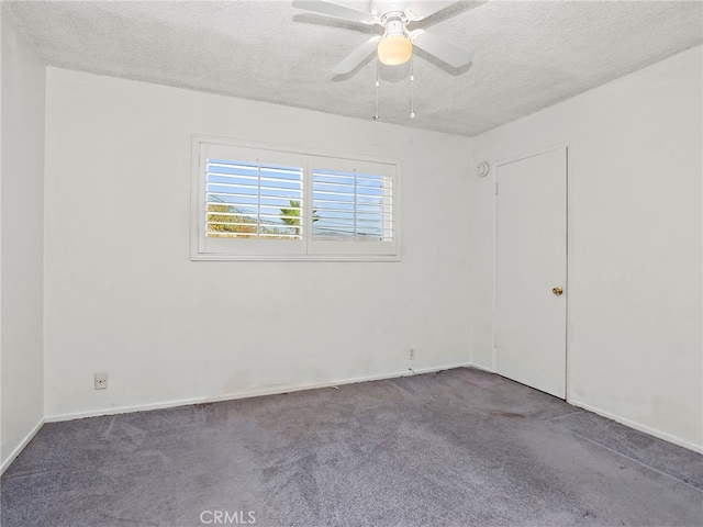 carpeted spare room featuring ceiling fan and a textured ceiling