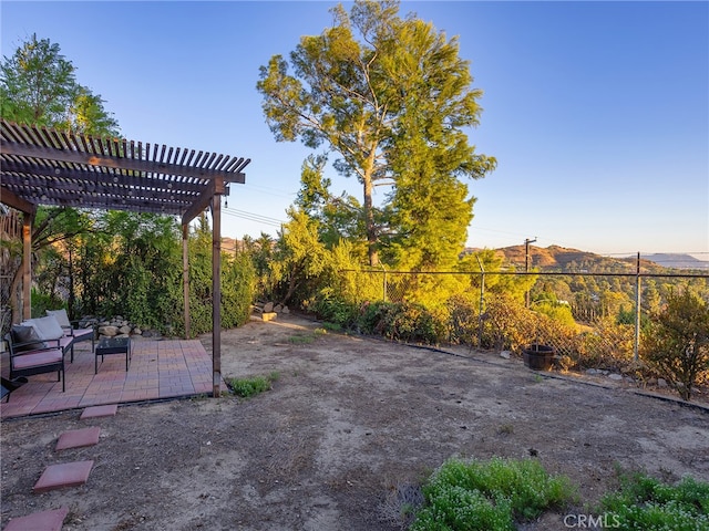 view of patio with a mountain view and a pergola