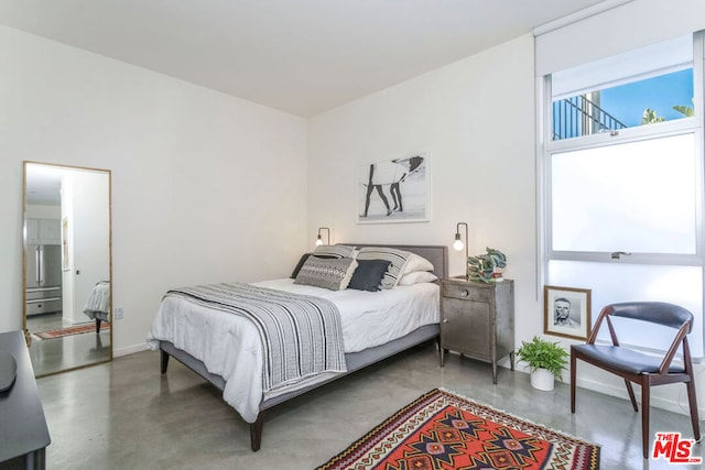 bedroom featuring concrete floors