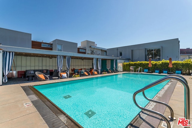 view of pool featuring a patio