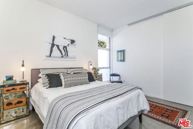 bedroom featuring concrete floors