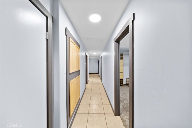 hall with light tile patterned floors