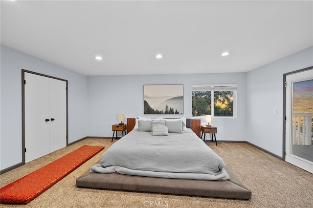 bedroom featuring access to exterior, a closet, and light colored carpet