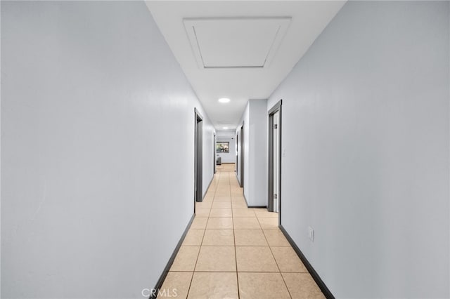 hall with light tile patterned floors