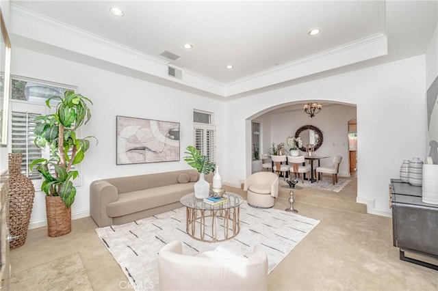 living room with crown molding and a notable chandelier