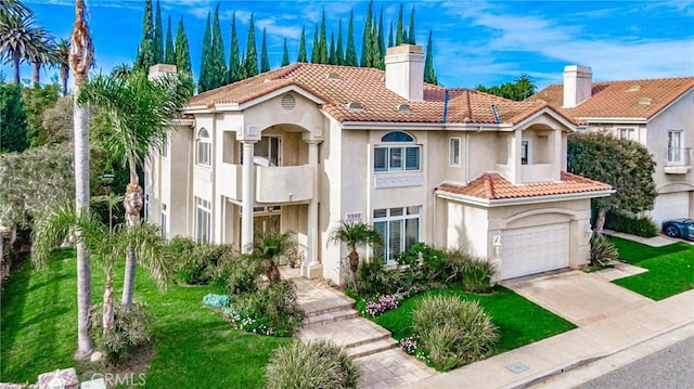 mediterranean / spanish-style house with a front yard and a garage