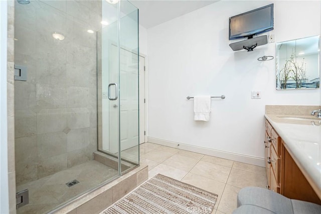 bathroom with tile patterned floors, vanity, and walk in shower