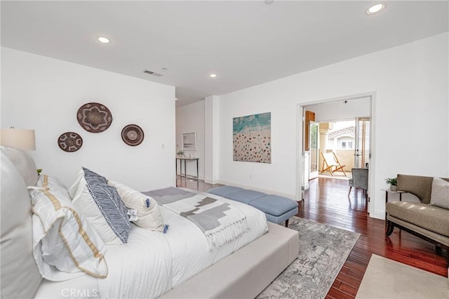 bedroom with dark hardwood / wood-style flooring