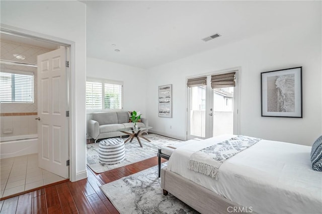 bedroom with french doors and wood-type flooring