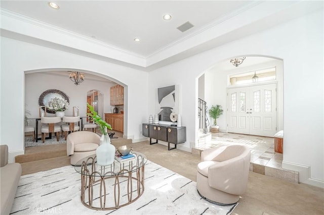 living room with a chandelier and ornamental molding