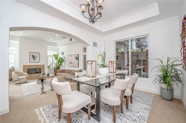 dining room with crown molding, a tray ceiling, and a chandelier