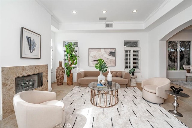 living room featuring a fireplace and ornamental molding