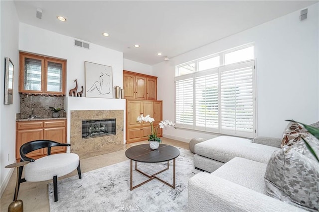 living room featuring a tiled fireplace