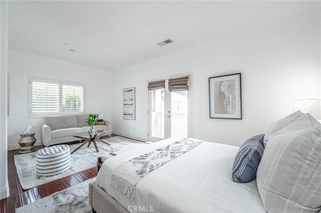 bedroom featuring hardwood / wood-style flooring and french doors