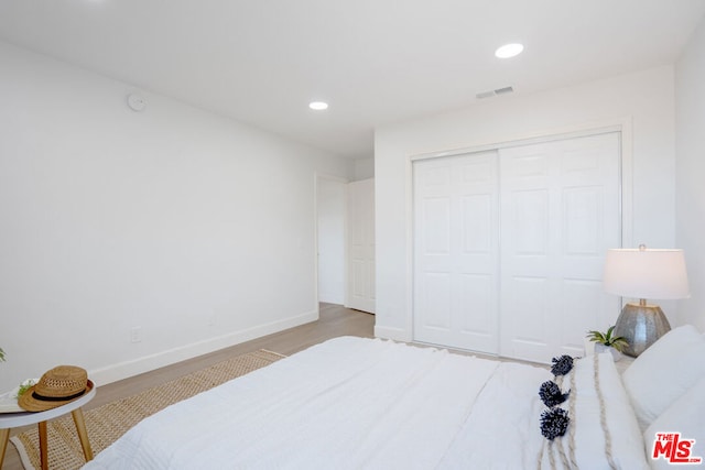 bedroom featuring a closet and light wood-type flooring