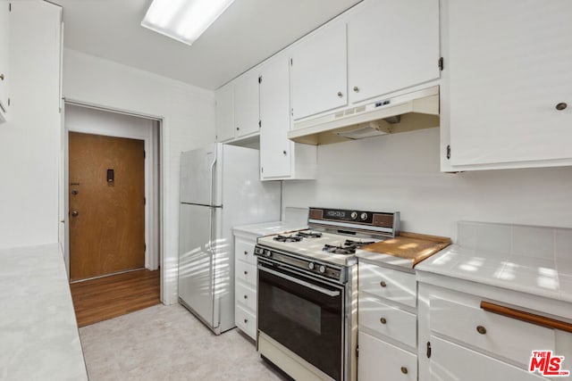 kitchen featuring white cabinetry, white appliances, and light hardwood / wood-style flooring