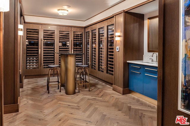 wine room with sink and light parquet flooring