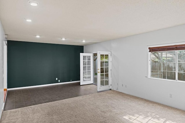 carpeted empty room with french doors