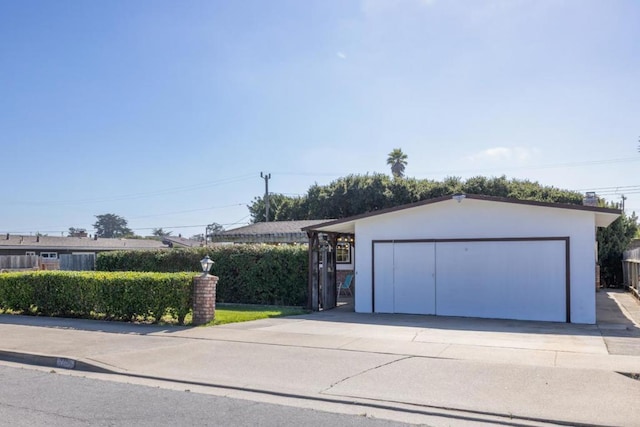 view of front facade featuring an outbuilding and a garage