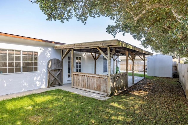 exterior space with a storage shed and a lawn