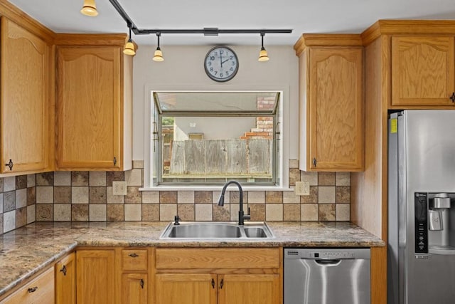 kitchen featuring sink, track lighting, plenty of natural light, and appliances with stainless steel finishes