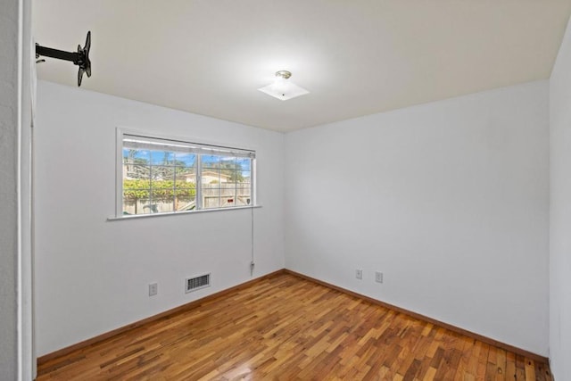 empty room featuring hardwood / wood-style flooring