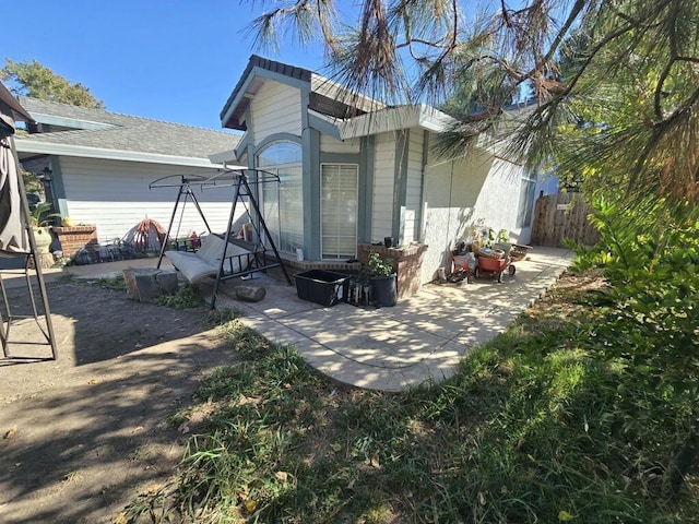 rear view of property featuring a patio area