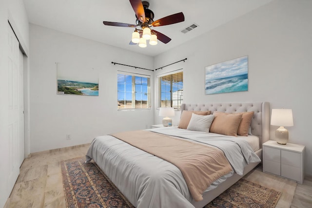 bedroom with ceiling fan, a closet, and light hardwood / wood-style flooring