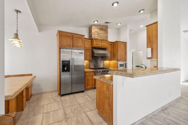 kitchen featuring tasteful backsplash, light stone counters, built in appliances, kitchen peninsula, and vaulted ceiling