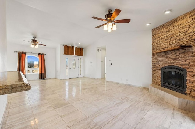 unfurnished living room featuring ceiling fan, a stone fireplace, and lofted ceiling