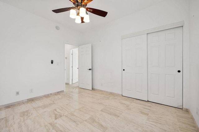 unfurnished bedroom with ceiling fan and a closet