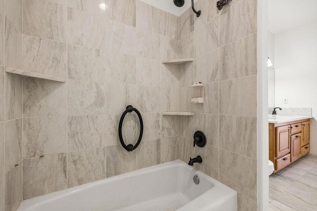 bathroom with vanity and tiled shower / bath