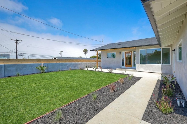 view of yard with a water view and a patio area