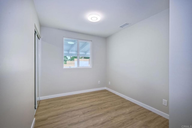 spare room featuring light hardwood / wood-style floors