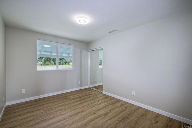 spare room with hardwood / wood-style flooring