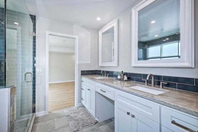 bathroom featuring vanity, hardwood / wood-style flooring, and a shower with door