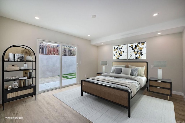 bedroom featuring access to exterior and hardwood / wood-style flooring