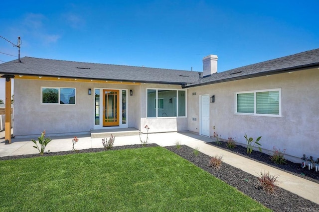 single story home featuring a front yard and a patio area