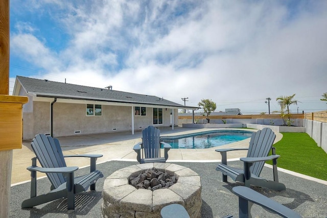 view of swimming pool with a fire pit and a patio