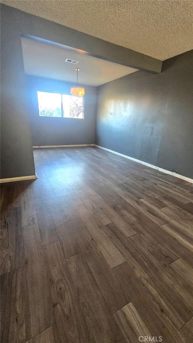 spare room featuring dark hardwood / wood-style flooring